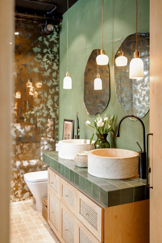 Luxury bathroom remodel featuring a custom double vanity, vessel sinks, modern lighting, and designer finishes by Green Men Restoration in Indianapolis.
